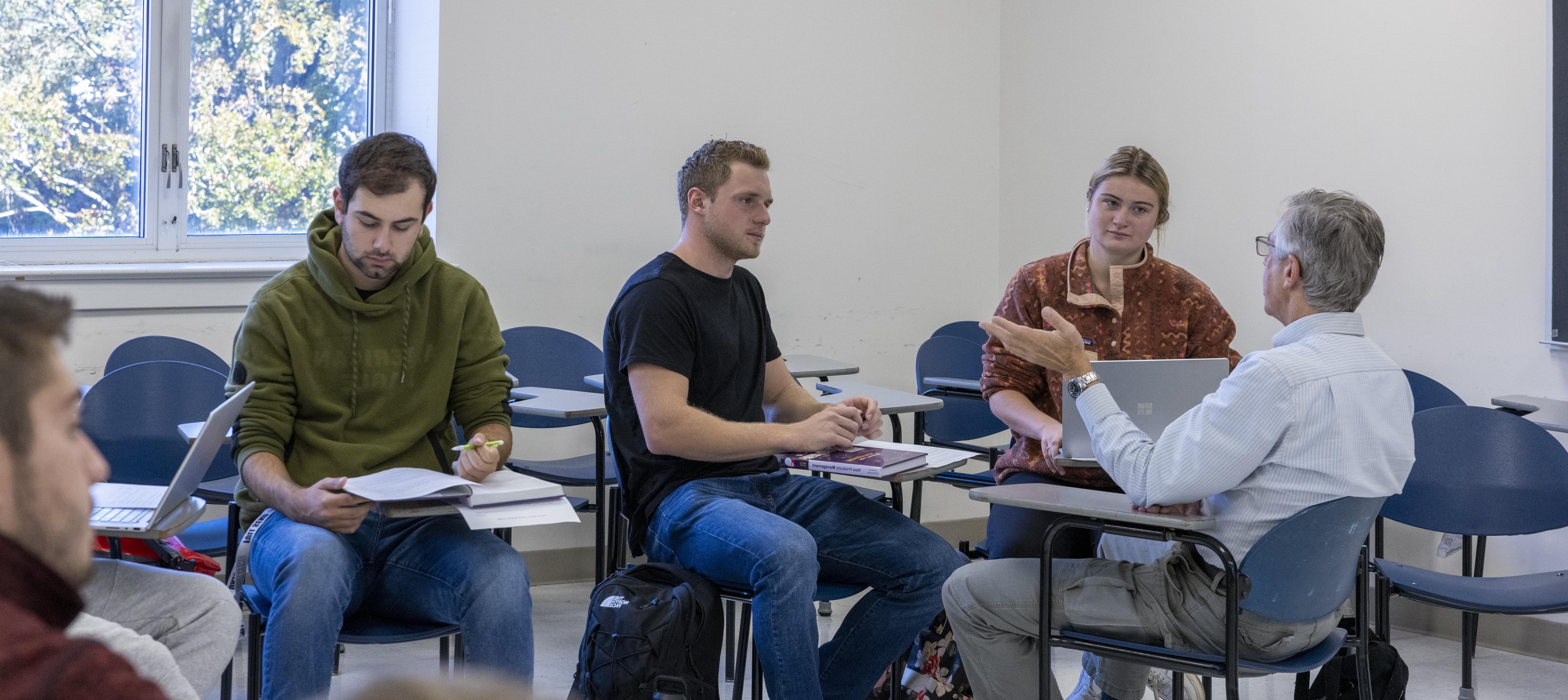 Students in discussion with professor